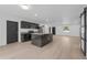 Open-concept kitchen with stylish black cabinets, stainless steel appliances, and a large marble island at 1520 Arnold Ave, Brooksville, FL 34601