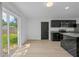 Bright kitchen with white walls, black cabinets and island, and sliding glass doors leading to the backyard at 1520 Arnold Ave, Brooksville, FL 34601