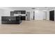 Open-concept kitchen featuring dark cabinets, stainless steel appliances, and a marble island at 1520 Arnold Ave, Brooksville, FL 34601