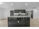 Spacious kitchen featuring a large island with marble countertop, stainless steel appliances, and ample cabinet space at 1520 Arnold Ave, Brooksville, FL 34601