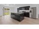 Modern kitchen showcasing black cabinets, a marble island, and stainless steel appliances for a sleek, contemporary look at 1520 Arnold Ave, Brooksville, FL 34601
