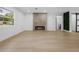Spacious living room with a sleek fireplace, wood-look flooring, and a modern barn door leading to the bathroom at 1520 Arnold Ave, Brooksville, FL 34601