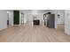 Open-concept living space with wood floors, a stylish barn door, and modern kitchen island at 1520 Arnold Ave, Brooksville, FL 34601