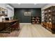 Stylish office with a modern accent wall, wooden desk, and ample shelving for a functional workspace at 1520 Arnold Ave, Brooksville, FL 34601