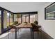 Enclosed patio with ample sunlight featuring a wooden table and chairs at 1520 Arnold Ave, Brooksville, FL 34601
