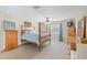 Spacious bedroom featuring a four-poster bed, light-colored walls, and a ceiling fan at 16209 Carnoustie Dr, Odessa, FL 33556