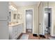 Clean bathroom featuring a vanity with sink and mirror, a walk-in shower, and neutral tile at 2105 Cordova Grn # 2105, Seminole, FL 33777