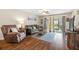 Cozy living room with wood floors, comfortable seating, and natural light at 2105 Cordova Grn # 2105, Seminole, FL 33777