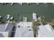 Aerial view of the property highlighting the private boat dock, waterway access, and lush tropical landscaping at 212 176Th Terrace E Dr, Redington Shores, FL 33708