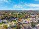 Panoramic aerial view of a neighborhood, featuring houses, trees, and roads on a sunny day with scattered clouds at 2713 W Osborne Ave, Tampa, FL 33614
