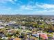 Urban aerial view showcasing residential homes, commercial buildings, lush trees, and blue skies at 2713 W Osborne Ave, Tampa, FL 33614