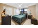 Bedroom with tile floors, ceiling fan, and a modern bed frame and closet doors at 2713 W Osborne Ave, Tampa, FL 33614