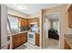 Well-equipped kitchen with wooden cabinets and access to adjacent living spaces at 2713 W Osborne Ave, Tampa, FL 33614