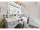 Laundry room includes washer, dryer, storage cabinets, and a bright window at 2713 W Osborne Ave, Tampa, FL 33614