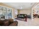 Cozy living room featuring a leather sofa, ceiling fan, and sliding glass door at 2713 W Osborne Ave, Tampa, FL 33614