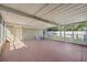 Spacious covered patio with white wicker seating, ideal for enjoying the outdoors in comfort and style at 2713 W Osborne Ave, Tampa, FL 33614