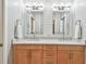Bright bathroom features a double vanity with a white countertop, two mirrors, and modern lighting fixtures at 337 4Th S Ave, St Petersburg, FL 33701