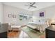 Bright bedroom with hardwood floors, a plush bed with patterned bedding, a seating area, and neutral decor at 337 4Th S Ave, St Petersburg, FL 33701