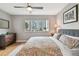 Cozy bedroom with large window, patterned bedding, and hardwood floors offers comfortable living space at 337 4Th S Ave, St Petersburg, FL 33701