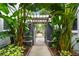 Inviting entrance to Charles Court with lush tropical landscaping and a charming pergola at 337 4Th S Ave, St Petersburg, FL 33701