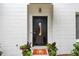 Modern front door with a window, enhanced by decorative plants and doormat at 337 4Th S Ave, St Petersburg, FL 33701