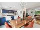 Open-concept kitchen and dining area with navy cabinets, stainless steel appliances, and modern lighting at 337 4Th S Ave, St Petersburg, FL 33701