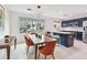 Modern kitchen with dark cabinets, white countertops, a large window, and a dining area that is ideal for gatherings at 337 4Th S Ave, St Petersburg, FL 33701