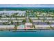 Community aerial view with a shared pool, tennis courts, marina and waterfront homes at 4744 Snook Se Dr, St Petersburg, FL 33705