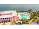 Overhead angle captures building, pool and pier with beach, palm trees and people enjoying the water at 4744 Snook Se Dr, St Petersburg, FL 33705