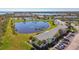 Beautiful aerial view of waterfront condos, a serene pond, and community tennis courts at 4744 Snook Se Dr, St Petersburg, FL 33705