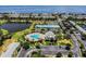 Panoramic aerial view showcasing the pool, tennis courts, lush landscaping, and waterfront location of this community at 4744 Snook Se Dr, St Petersburg, FL 33705