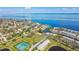 Overhead view of a beautiful community, with waterfront homes, a pond, and inviting tennis courts at 4744 Snook Se Dr, St Petersburg, FL 33705