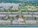 Aerial view of the waterfront community showcasing a pool, marina, and tennis courts at 4744 Snook Se Dr, St Petersburg, FL 33705