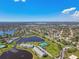 Scenic aerial perspective of a lush community featuring serene lakes and convenient tennis courts at 4744 Snook Se Dr, St Petersburg, FL 33705