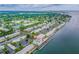Aerial view of the coastal community with a pool, tennis courts, boat docks, and waterfront homes at 4744 Snook Se Dr, St Petersburg, FL 33705