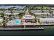 Aerial view of the beautiful community featuring lush landscaping, a pool, and stunning water views at 4744 Snook Se Dr, St Petersburg, FL 33705