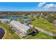 Scenic aerial shot of condos with a peaceful lake, tennis courts, and lush landscaping at 4744 Snook Se Dr, St Petersburg, FL 33705