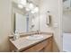 Bathroom with a single sink vanity, large mirror, and neutral wall color at 4744 Snook Se Dr, St Petersburg, FL 33705