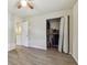 Bedroom features a closet with bi-fold doors, a ceiling fan, and wood-look flooring at 4744 Snook Se Dr, St Petersburg, FL 33705