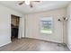 Bedroom featuring a window overlooking the yard, closet with doors, and wood-look flooring at 4744 Snook Se Dr, St Petersburg, FL 33705