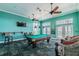 Inviting billiards room with a pool table, lounge seating, and a wall-mounted TV at 4744 Snook Se Dr, St Petersburg, FL 33705