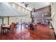 Spacious common area with hardwood floors, tables, chairs, and elegant lighting fixtures at 4744 Snook Se Dr, St Petersburg, FL 33705