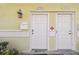 Close-up of two front doors featuring updated hardware and exterior lighting at 4744 Snook Se Dr, St Petersburg, FL 33705