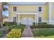 Charming two-story condo with a white pergola and lush landscaping at 4744 Snook Se Dr, St Petersburg, FL 33705