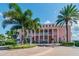 Charming, pink two-story building entrance with well-maintained landscaping and brick walkway at 4744 Snook Se Dr, St Petersburg, FL 33705
