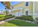 Inviting two-story condo with vibrant yellow walls, white trim, and palm trees at 4744 Snook Se Dr, St Petersburg, FL 33705