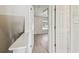 Hallway with an open door to a bedroom that has a window and wood look flooring at 4744 Snook Se Dr, St Petersburg, FL 33705