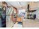 Functional kitchen with wood cabinets, stainless steel refrigerator, and granite countertops at 4744 Snook Se Dr, St Petersburg, FL 33705