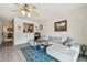 Open living room with a view into kitchen, ceiling fan, and modern furniture at 4744 Snook Se Dr, St Petersburg, FL 33705