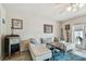 Bright living room features modern furniture, wood-look flooring, and a ceiling fan at 4744 Snook Se Dr, St Petersburg, FL 33705